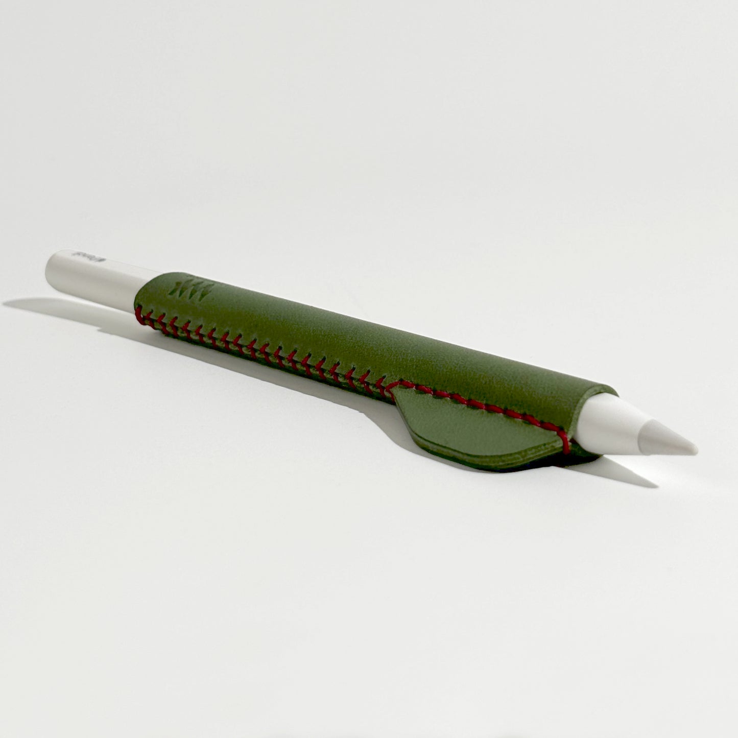 Apple Pencil accessory: hand-stitched ergonomic leather holder in green, perfect for artists and note-takers seeking better grip and style.