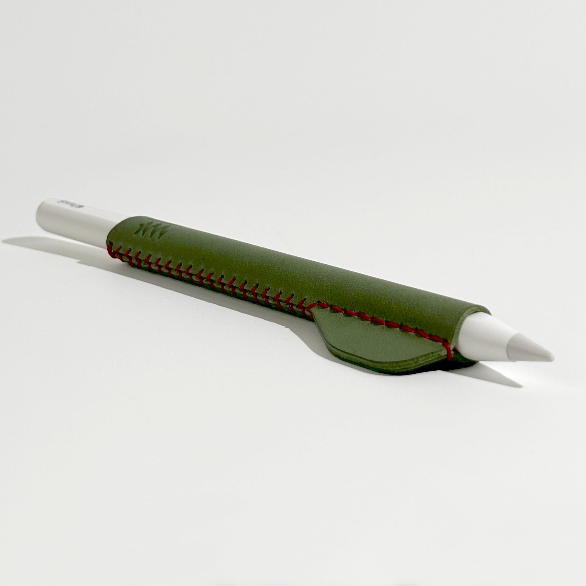 Apple Pencil accessory: hand-stitched ergonomic leather holder in green, perfect for artists and note-takers seeking better grip and style.