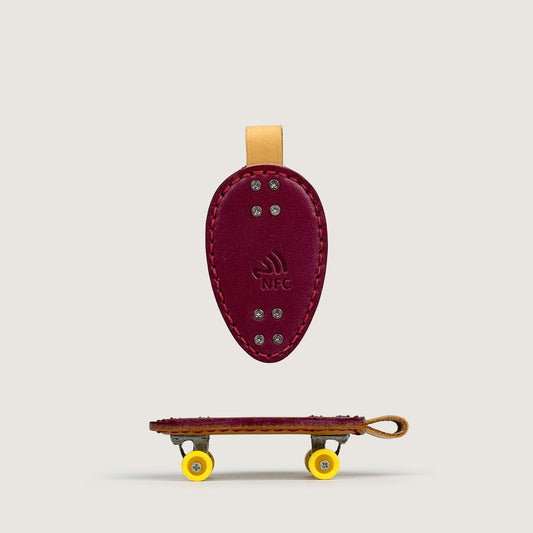 Personalized purple Veg-Tan Leather mini Skateboard Keychain with NTAG213 NFC chip.