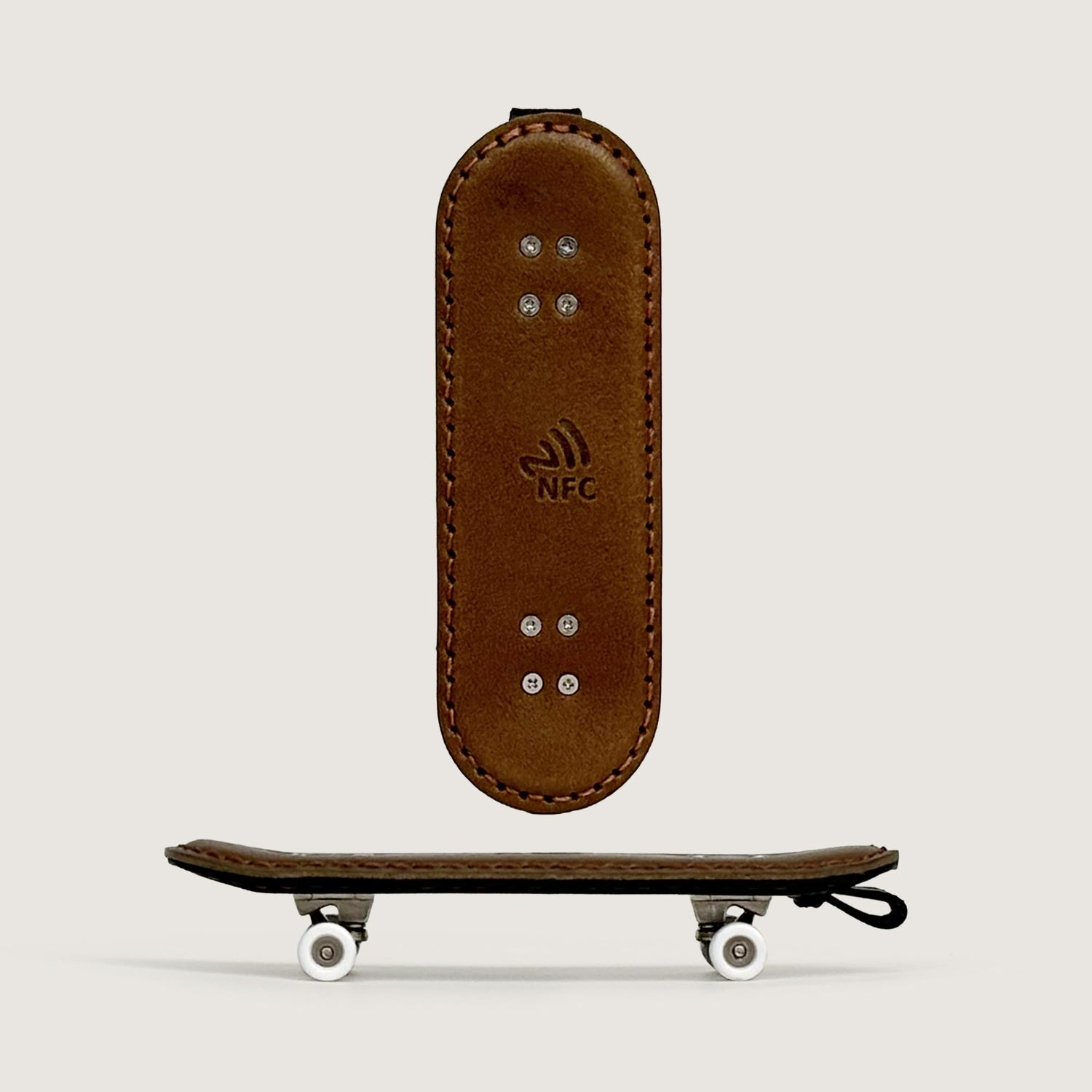Leather double kick skateboard bag charm shown in a clean front display.