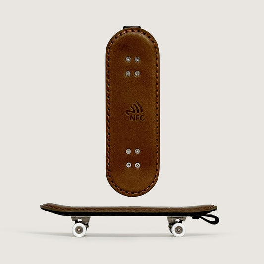 Leather double kick skateboard bag charm shown in a clean front display.