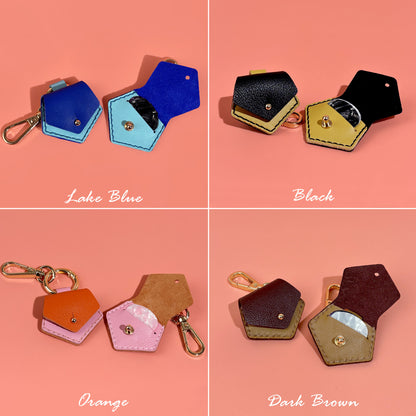 Stylish and practical leather guitar pick pouch keychains, featuring a secure snap closure, offered in Lake Blue, Black, Orange, and Dark Brown for easy pick storage.
