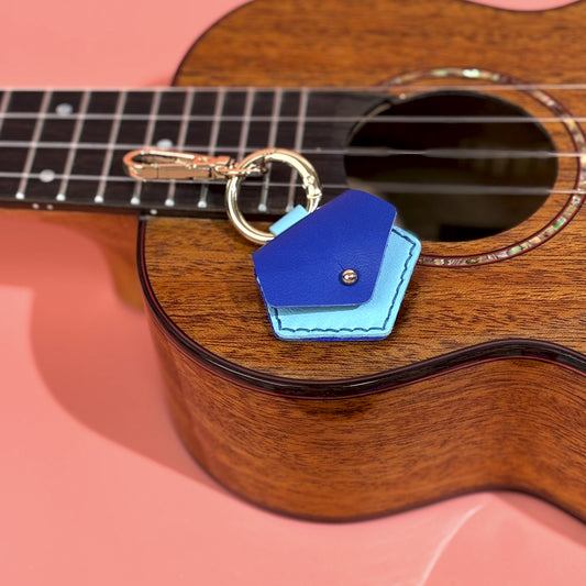 Artisan crafted blue leather guitar pick case keychain, designed for musicians seeking a convenient and elegant solution for pick storage.