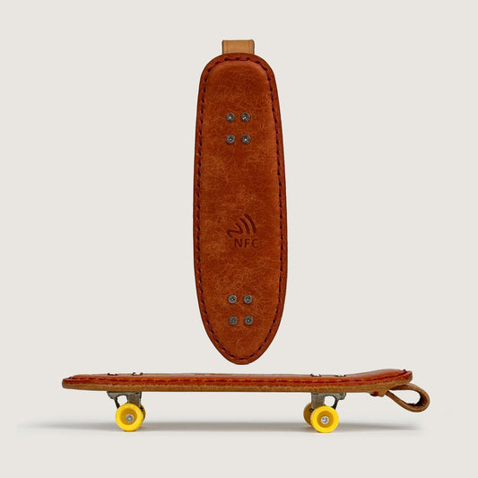 Personalized Veg-Tan Leather Cruiser Skateboard Keychain with visible NFC tag.