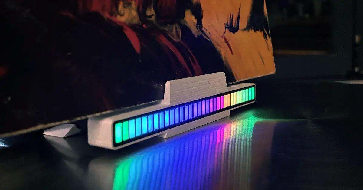 LLKworks audio visualizer vinyl stand in premium marble-textured white finish, showcasing a glowing sound-reactive LED display on a modern record player setup.