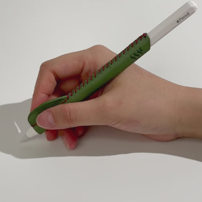 Demonstration video of an ergonomic, handmade green leather grip for Apple Pencil, showing improved comfort and control during use.