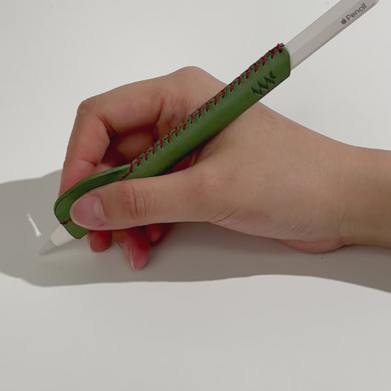 Demonstration video of an ergonomic, handmade green leather grip for Apple Pencil, showing improved comfort and control during use.