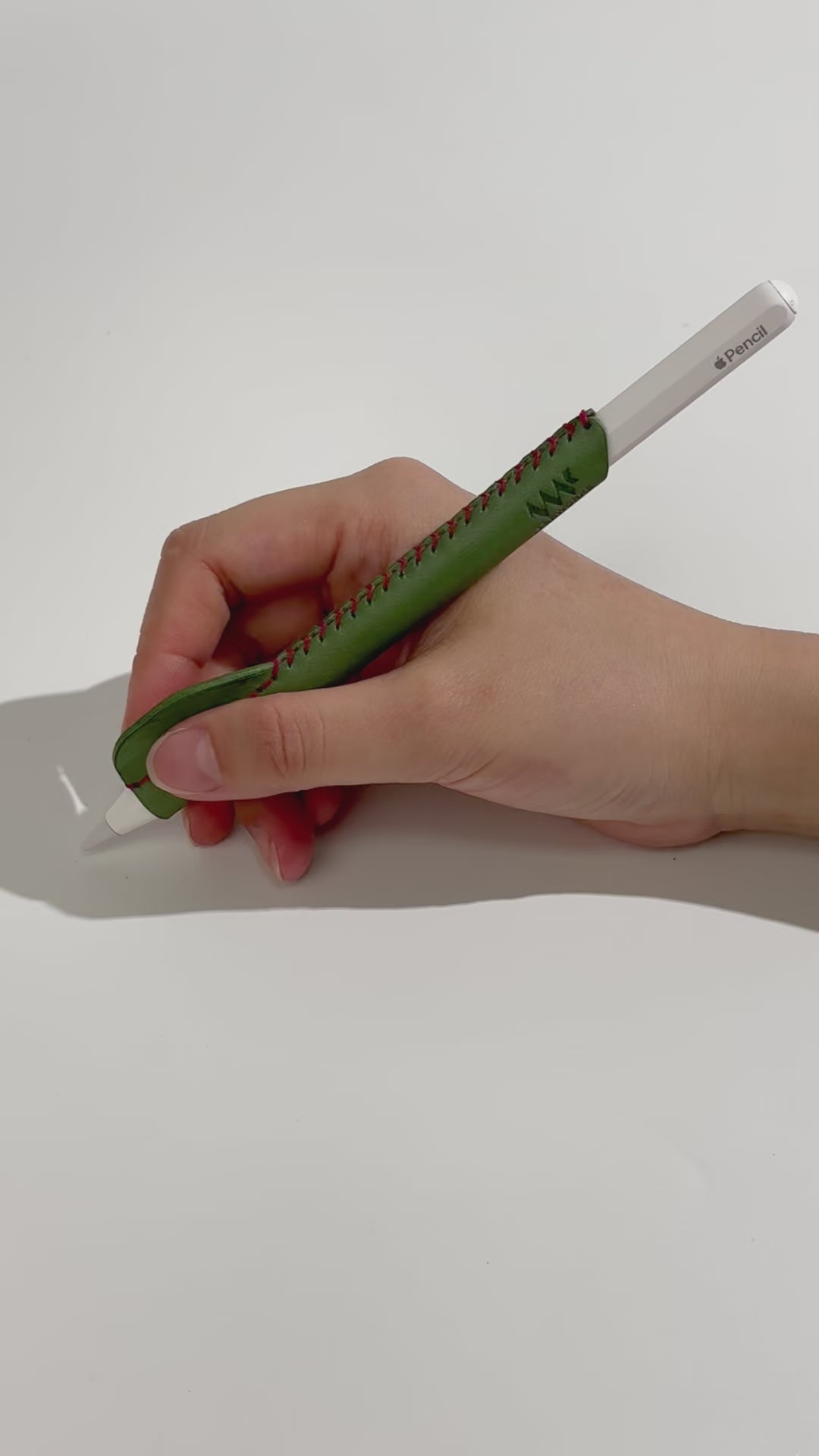 Demonstration video of an ergonomic, handmade green leather grip for Apple Pencil, showing improved comfort and control during use.