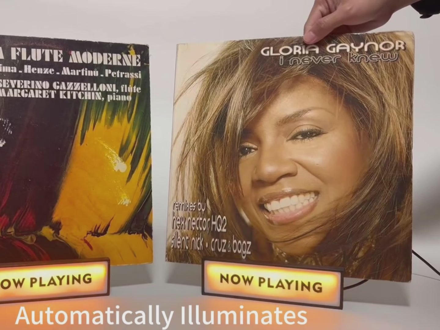 Demonstration of "Now Playing" vinyl record stands, illustrating how to set up and display album covers.
