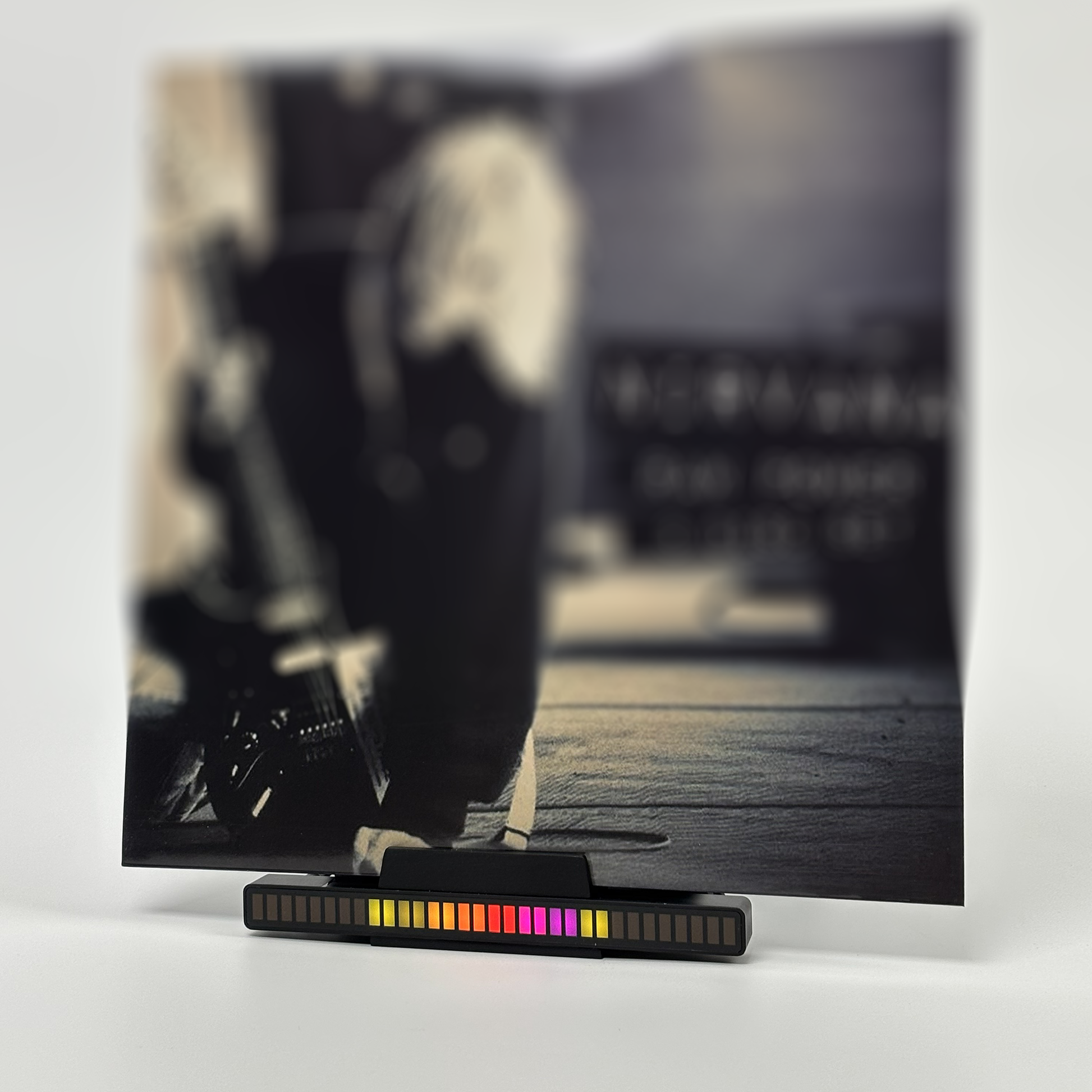 Vinyl record holder with music sync LED lighting effect on a desk.