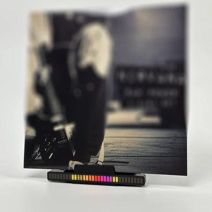 Vinyl record holder with music sync LED lighting effect on a desk.