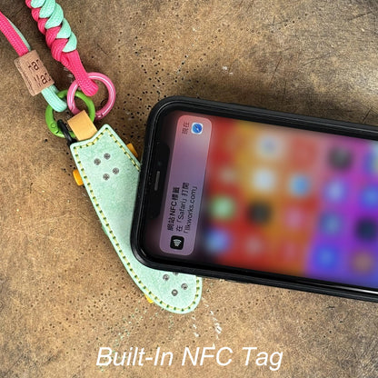 Smart NFC tag built into a skateboard keychain, showing smartphone scanning interaction.