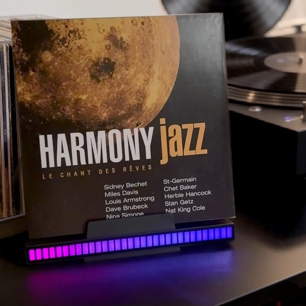Sound reactive vinyl record stand with RGB LED music visualizer, displaying a jazz record on a turntable setup. Perfect for audiophiles and home office decor.
