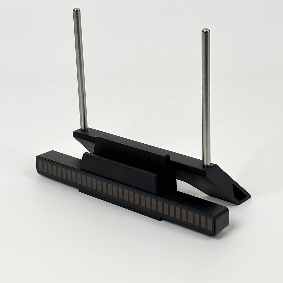 Modern minimalist design of black vinyl record stand with stainless steel support rods.